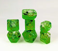 Set of green dice with gold numbers on a white background